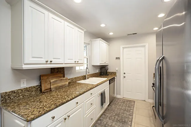 a kitchen with a sink stove and refrigerator