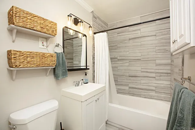 a bathroom with a sink a toilet and shower