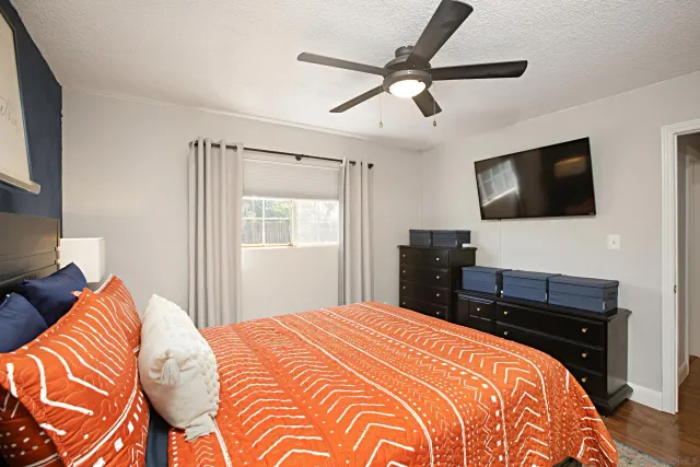 a bedroom with a bed and a flat screen tv