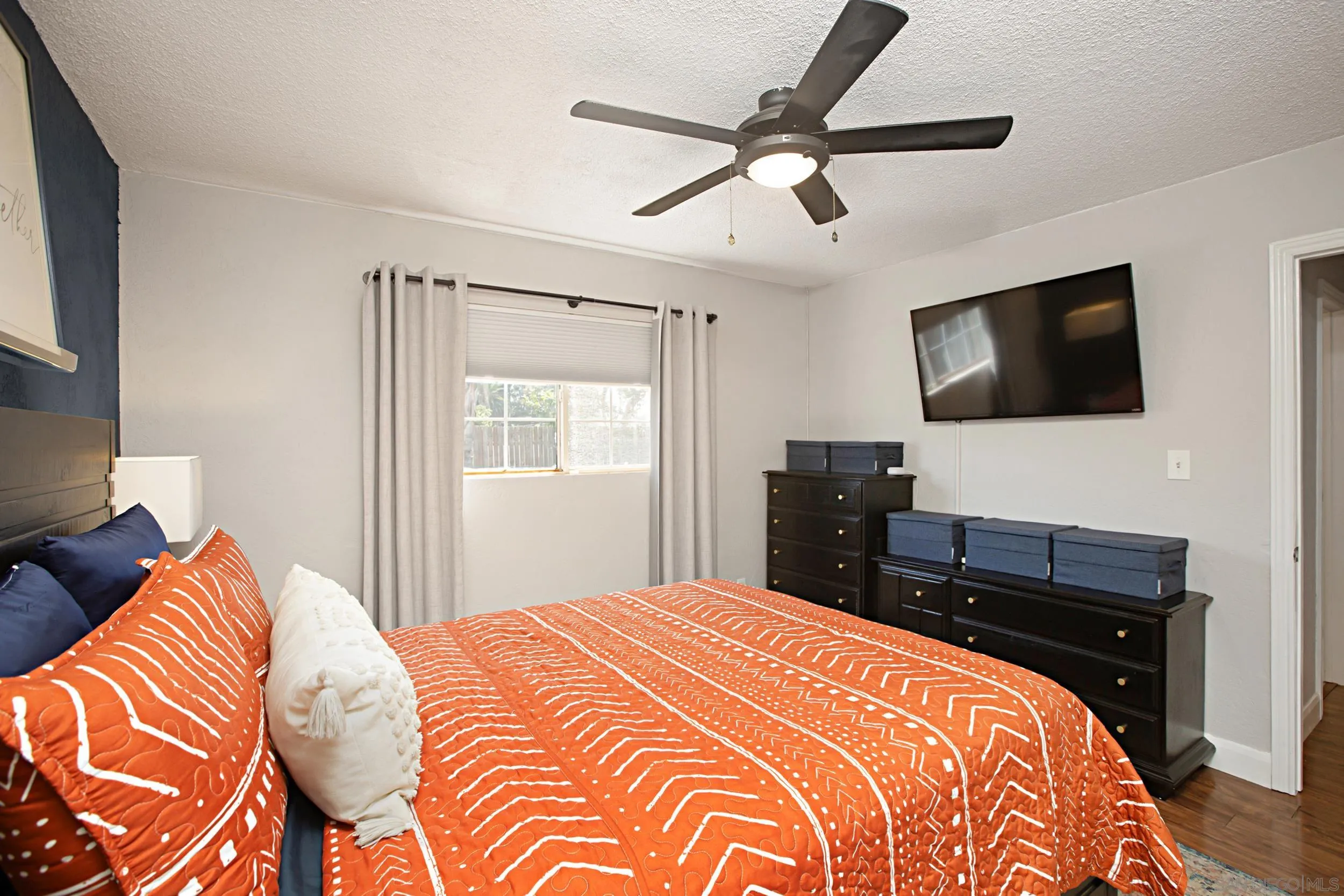 8823 Kelburn Avenue Spring Valley, CA 91977 - Photo 20 of 34 a bedroom with a bed and a flat screen tv