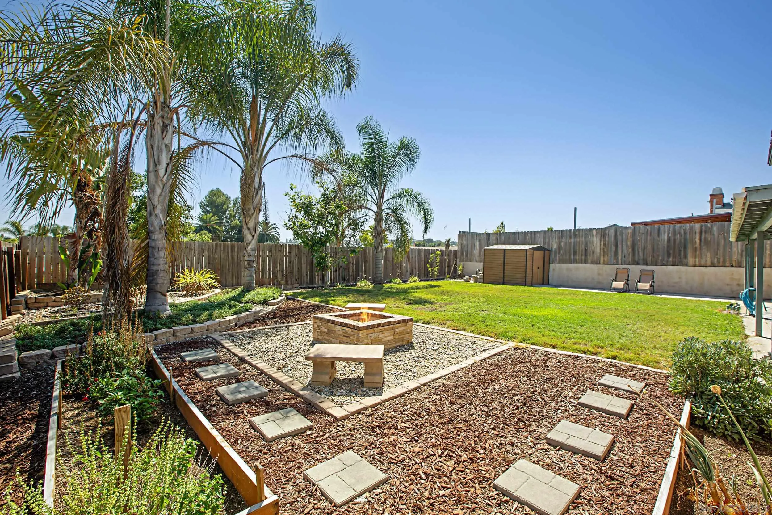 8823 Kelburn Avenue Spring Valley, CA 91977 - Photo 25 of 34 a view of a backyard with couches plants and wooden fence