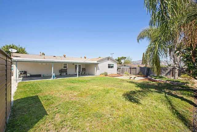 a view of a house with a backyard