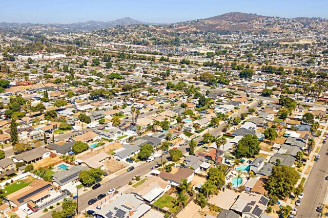 an aerial view of residential houses with city view