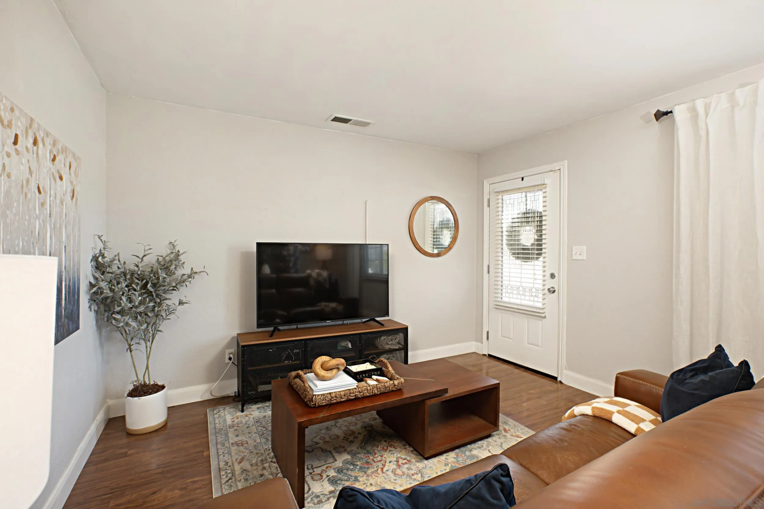 8823 Kelburn Avenue Spring Valley, CA 91977 - Photo 7 of 34 a living room with furniture and a flat screen tv