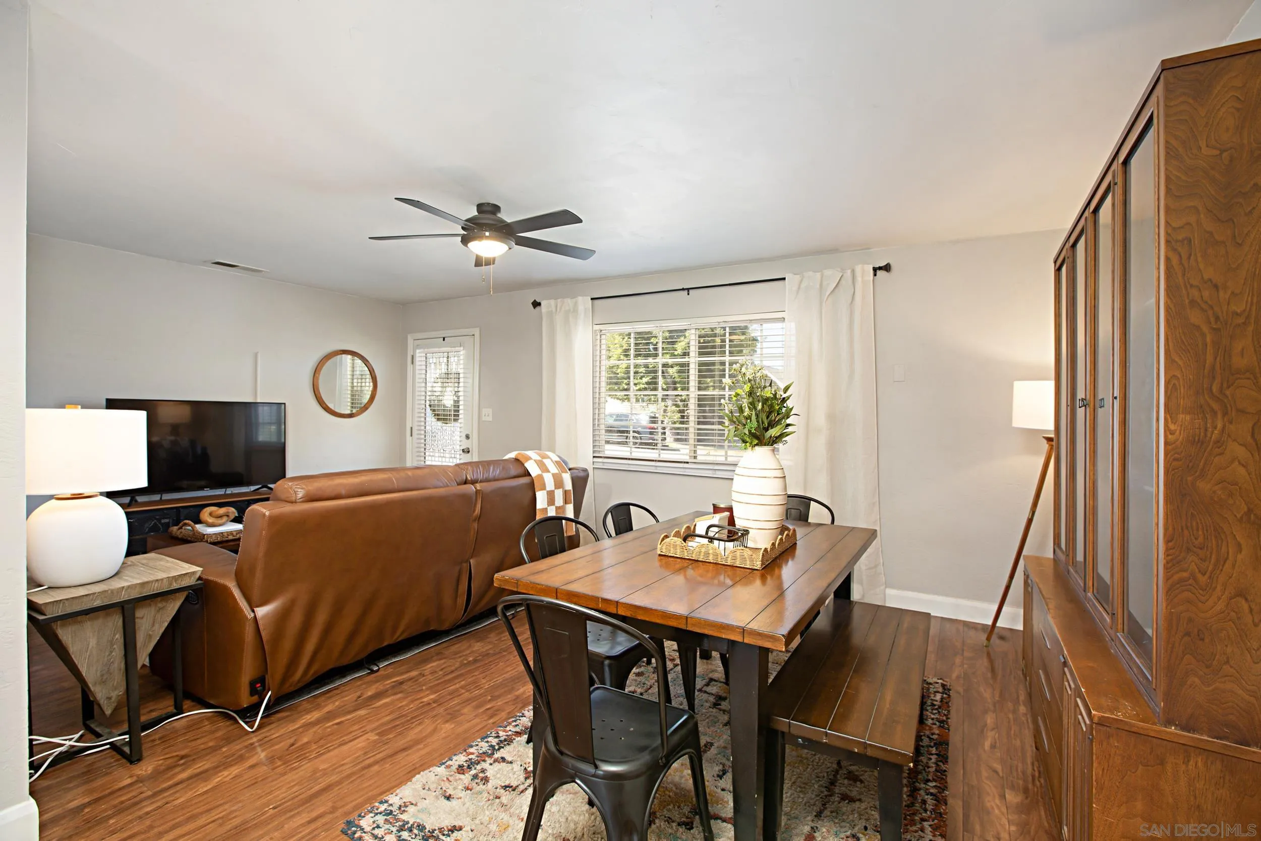 8823 Kelburn Avenue Spring Valley, CA 91977 - Photo 9 of 34 a living room with furniture a flat screen tv and a window