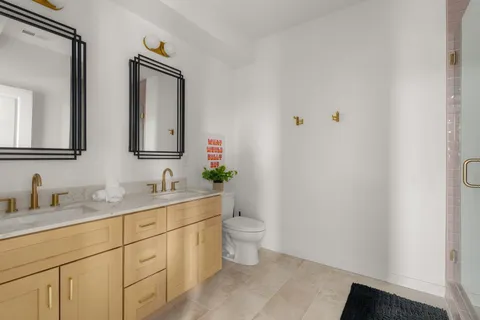 a bathroom with a toilet sink and mirror