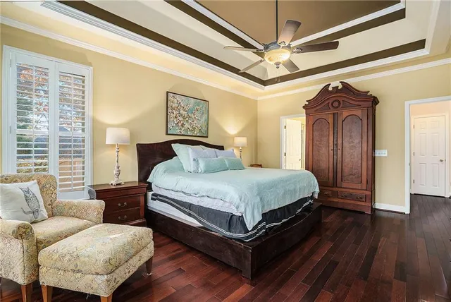 a bedroom with a bed couch and a window