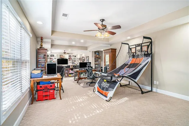 a room with gym equipment and a view of living room