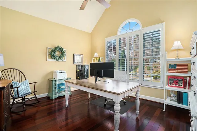 a view of a workspace with furniture and wooden floor