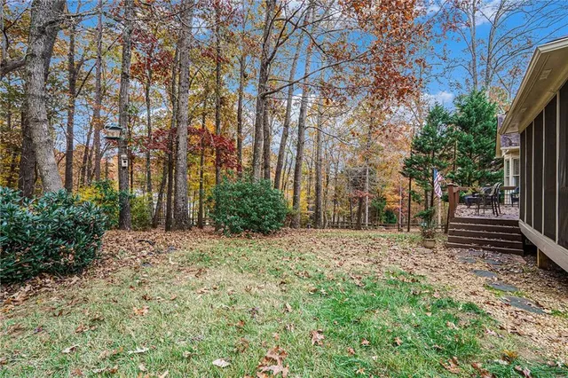 a view of a yard with large trees