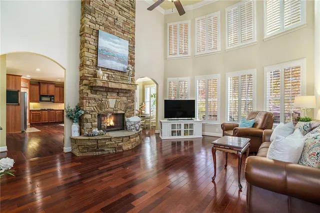 a living room with furniture wooden floor and a flat screen tv