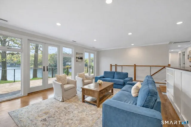 a living room with furniture and a floor to ceiling window