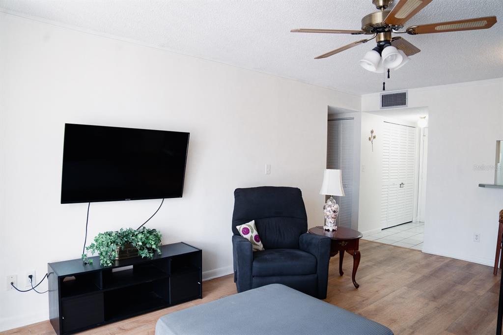 519 Albee Farm Road, Unit 110 Venice, FL 34285 - Photo 21 of 33 a living room with furniture and a flat screen tv