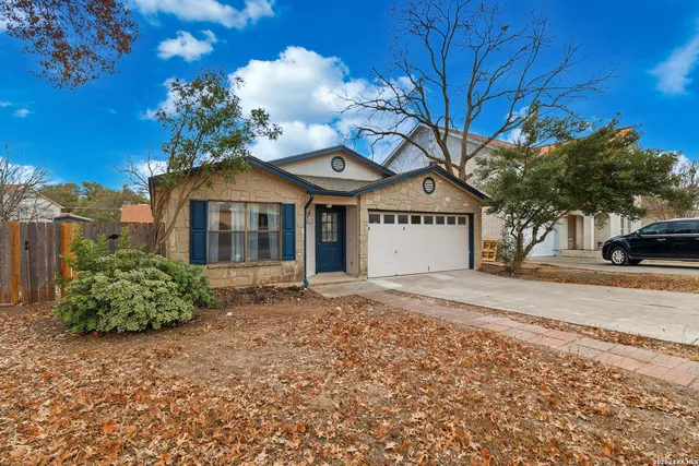a view of backyard with wooden fence and seating