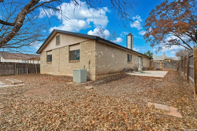 a view of a backyard with a tree
