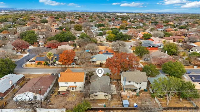 an aerial view of residential houses with outdoor space