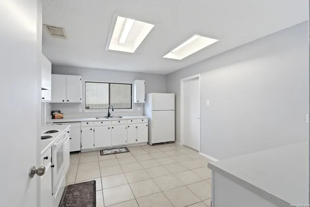 a kitchen with cabinets and window