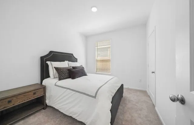 a bed room with a bed and a window