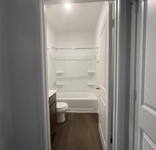 a bathroom with a bathtub and a toilet