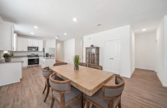a view of a dining room with furniture and wooden floor