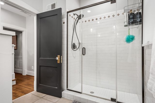 a bathroom with a glass shower door