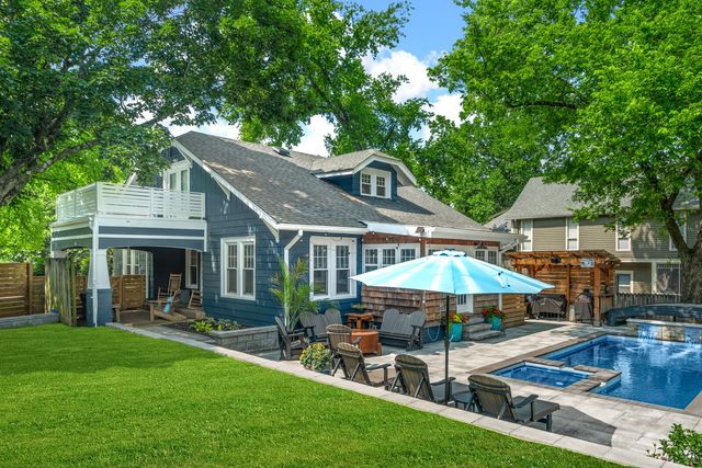 a front view of a house with a garden