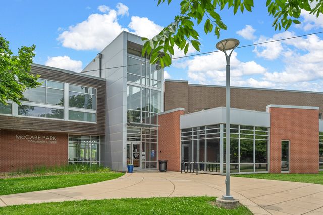 a sign that is sitting on a green field