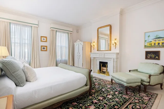 a spacious bedroom with a bed and a fireplace