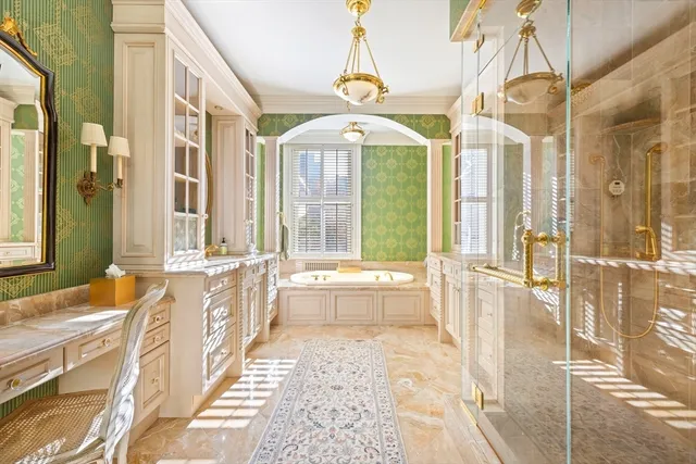 a large spacious bathroom with a granite countertop tub shower and sink