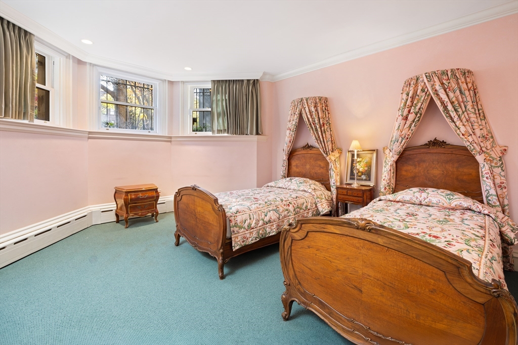 129 Commonwealth Avenue, Unit SF Boston, MA 02116 - Photo 18 of 19 a bedroom with two beds and painting on the wall