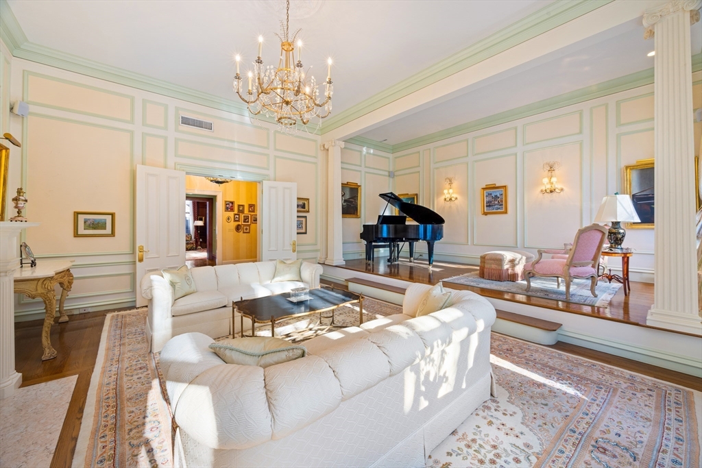 129 Commonwealth Avenue, Unit SF Boston, MA 02116 - Photo 2 of 19 a living room with fireplace furniture and a chandelier