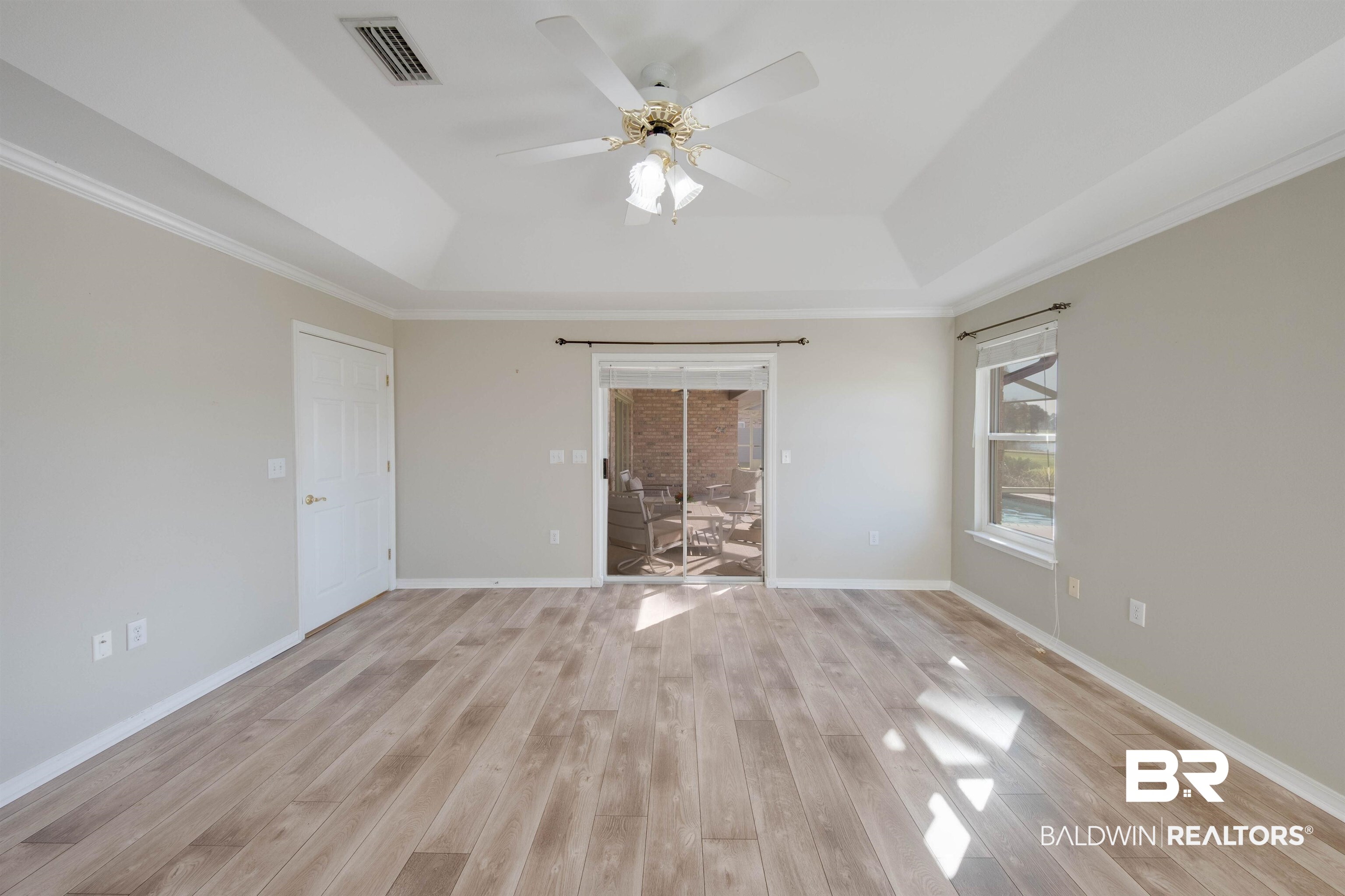 9462 Lakeview Drive Foley, AL 36535 - Photo 28 of 50 Master bedroom with crown molding, a raised ceiling, light wood-type flooring, and ceiling fan