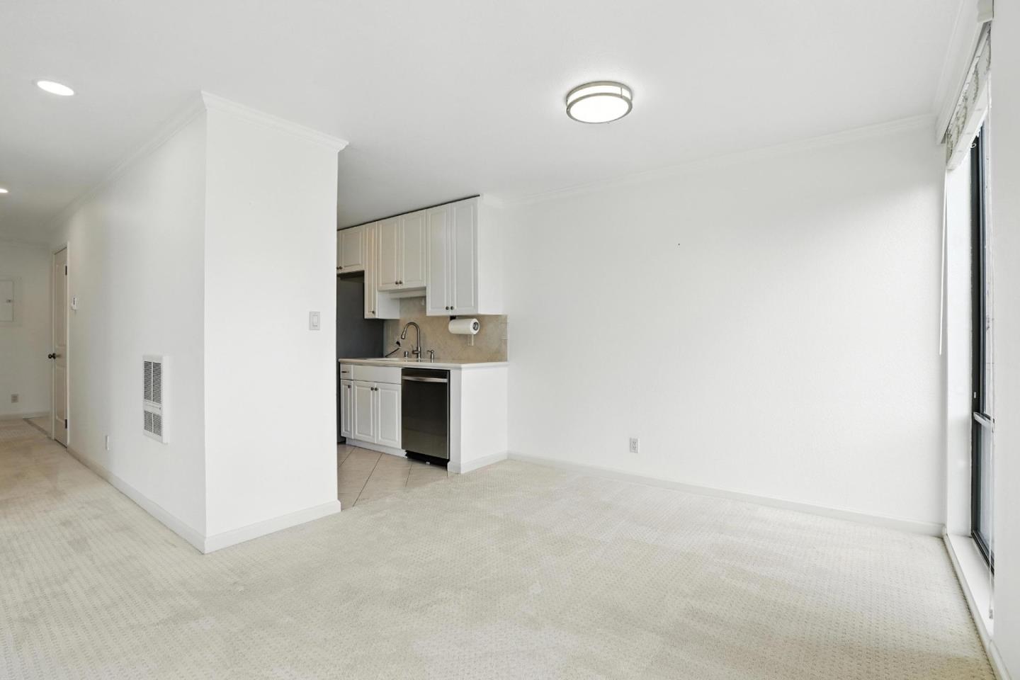 1171 Compass Lane, Unit 211 Foster City, CA 94404 - Photo 13 of 37 a view of kitchen with refrigerator and white cabinets