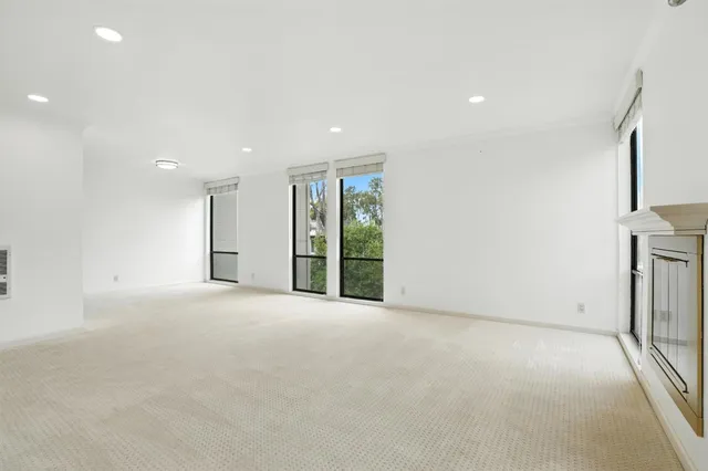 a view of an empty room with a fireplace