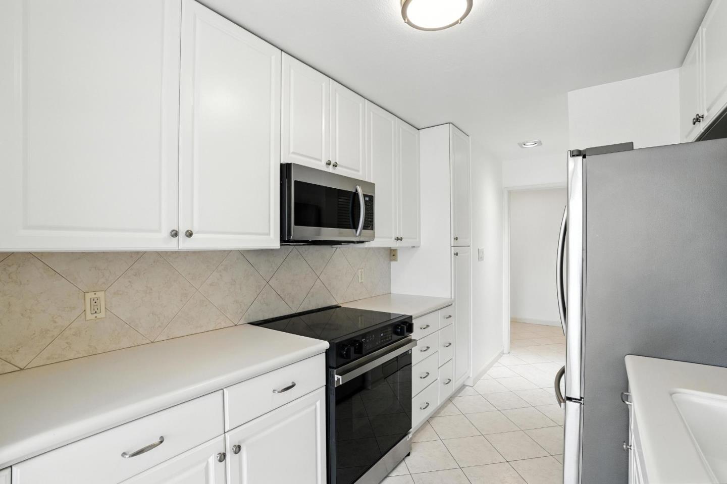 1171 Compass Lane, Unit 211 Foster City, CA 94404 - Photo 8 of 37 a kitchen with a sink and a refrigerator