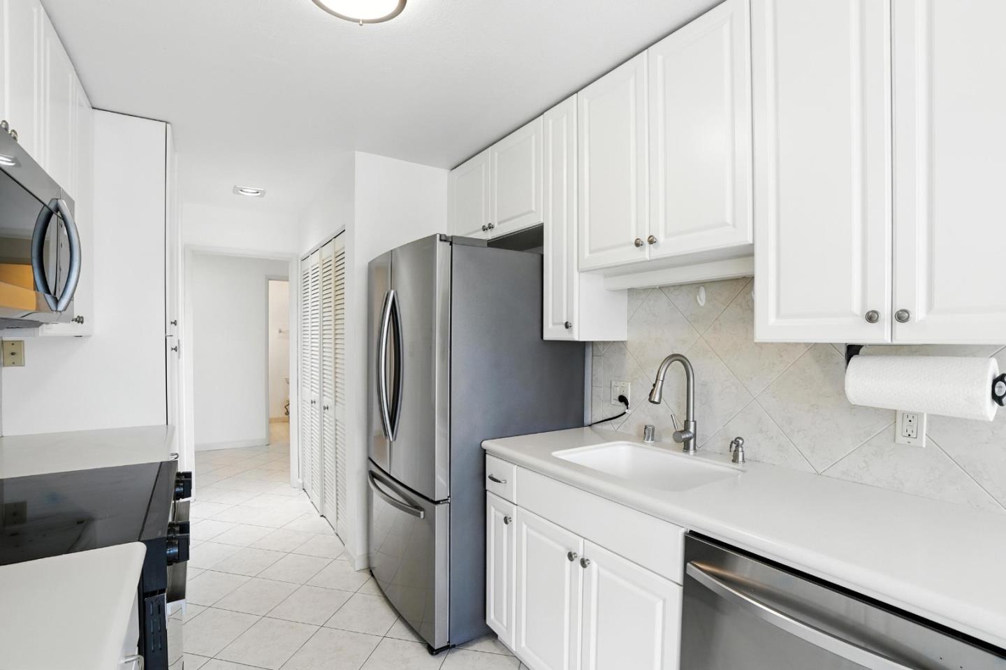 1171 Compass Lane, Unit 211 Foster City, CA 94404 - Photo 9 of 37 a kitchen with stainless steel appliances a refrigerator sink and cabinets