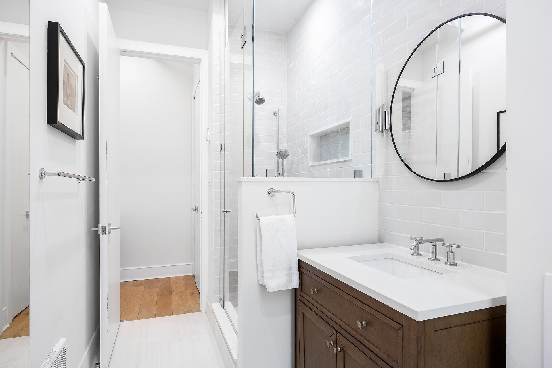 242 Lafayette Street, Unit 2N Manhattan, NY 10012 - Photo 12 of 13 a bathroom with a sink and a mirror