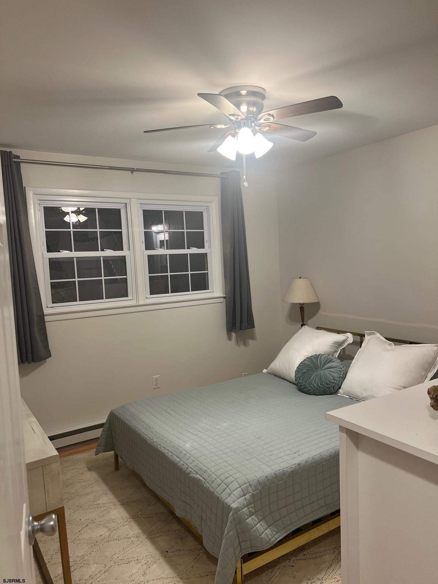1013 West Brigantine Avenue, Unit 4 Brigantine, NJ 08203 - Photo 11 of 18 a bedroom with a bed and a window