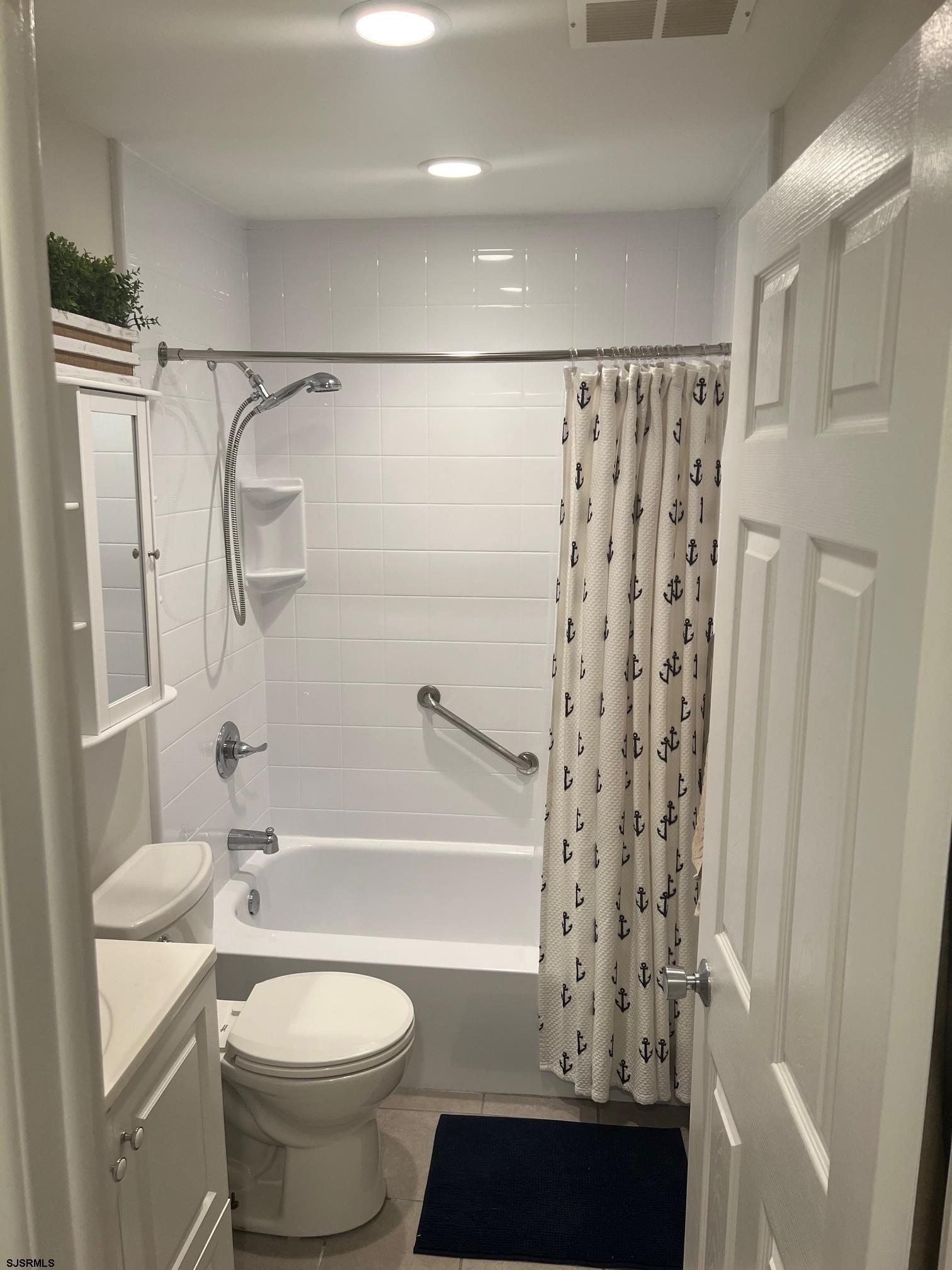 1013 West Brigantine Avenue, Unit 4 Brigantine, NJ 08203 - Photo 16 of 18 a bathroom with a toilet a sink and a shower