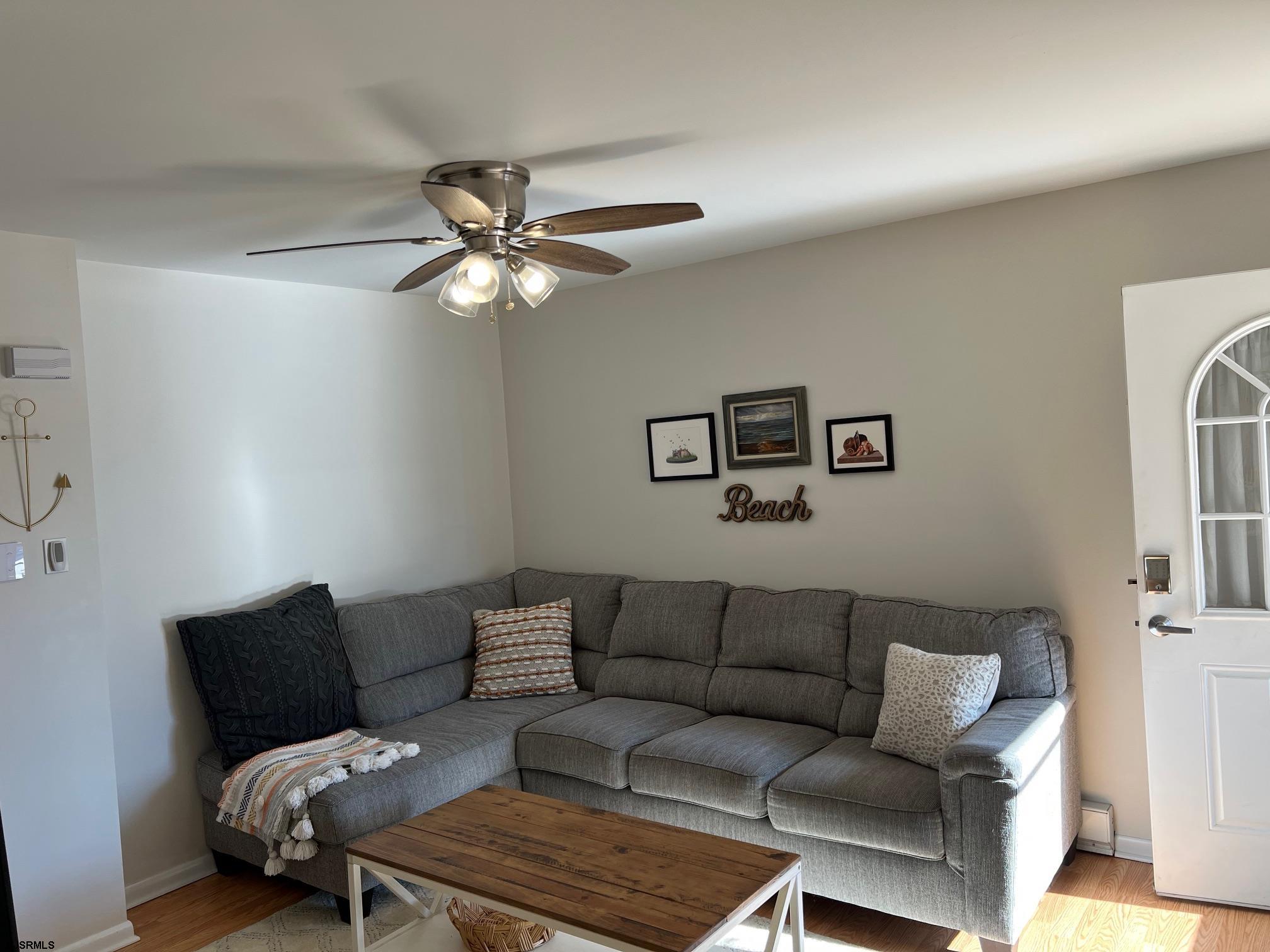 1013 West Brigantine Avenue, Unit 4 Brigantine, NJ 08203 - Photo 3 of 18 a living room with furniture a couch and a ceiling fan