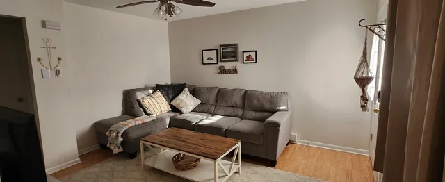 a blue couch sitting next to a small bathroom