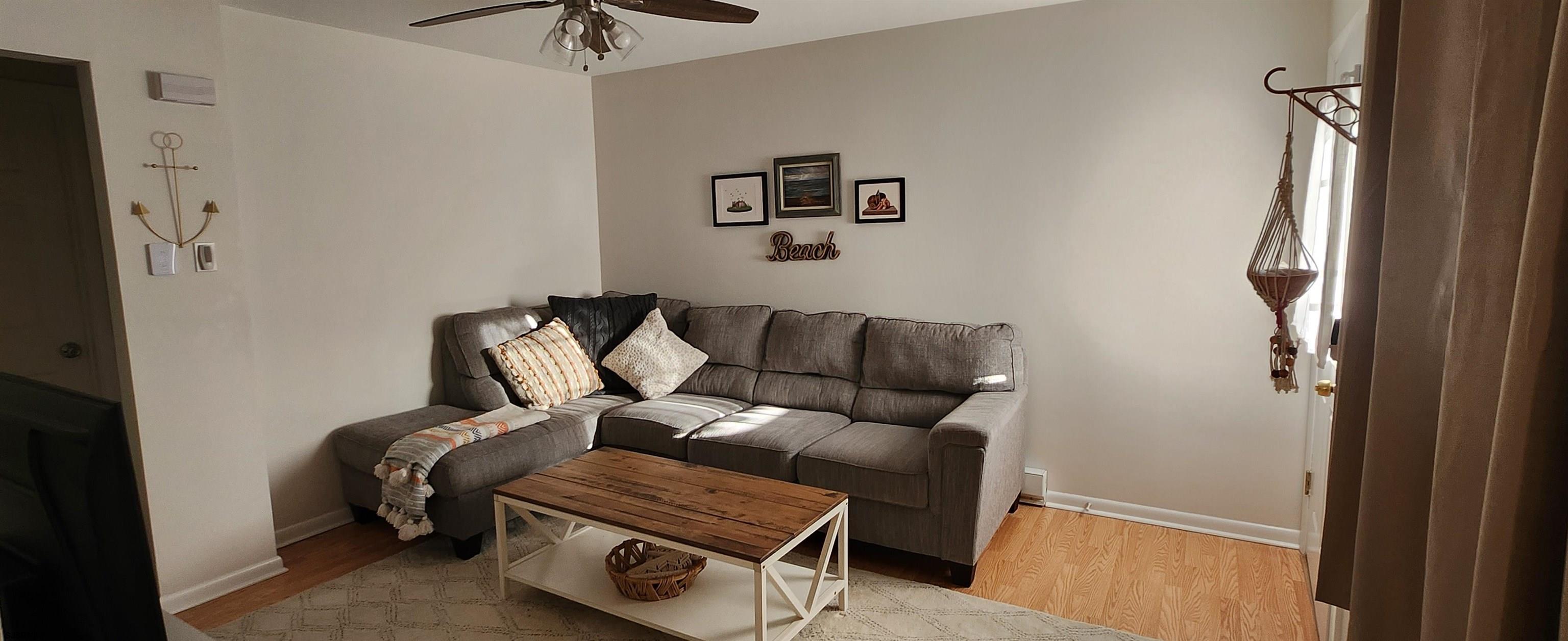 1013 West Brigantine Avenue, Unit 4 Brigantine, NJ 08203 - Photo 5 of 18 a blue couch sitting next to a small bathroom