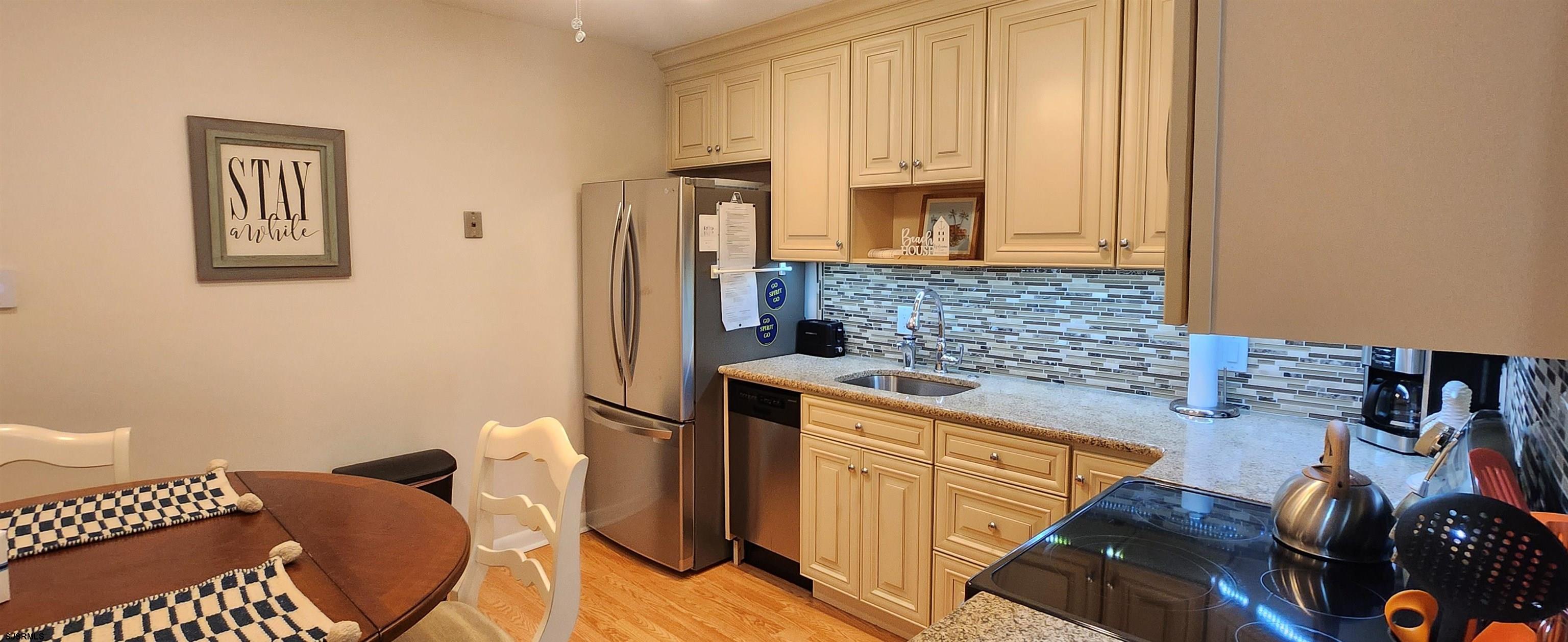 1013 West Brigantine Avenue, Unit 4 Brigantine, NJ 08203 - Photo 6 of 18 a kitchen with stainless steel appliances granite countertop a stove a sink and a microwave