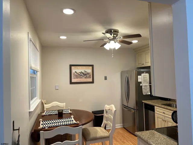 a living room with furniture a chandelier and a chair