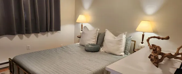 a view of a room with wooden floor and windows