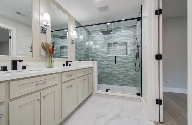 a bathroom with a shower sink and mirror