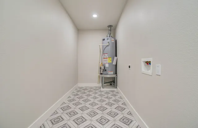 an empty room with a bench and a shower