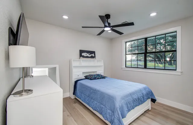 a bedroom with a bed and a window