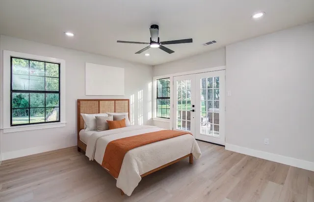 a bedroom with a large bed and a large window