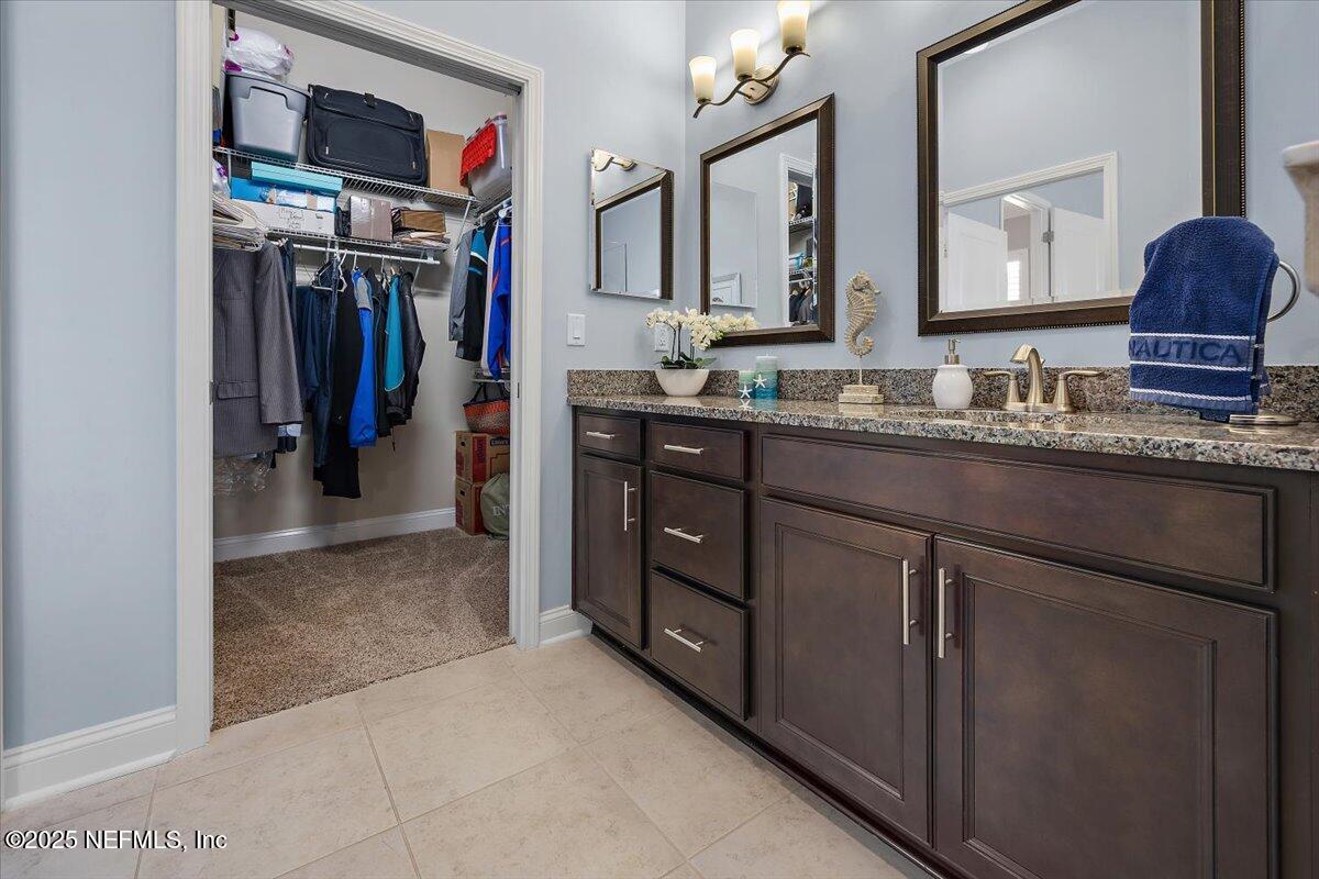 95220 Summerwoods Circle, Unit 1205 Fernandina Beach, FL 32034 - Photo 12 of 32 a view of a double vanity sink and a mirror